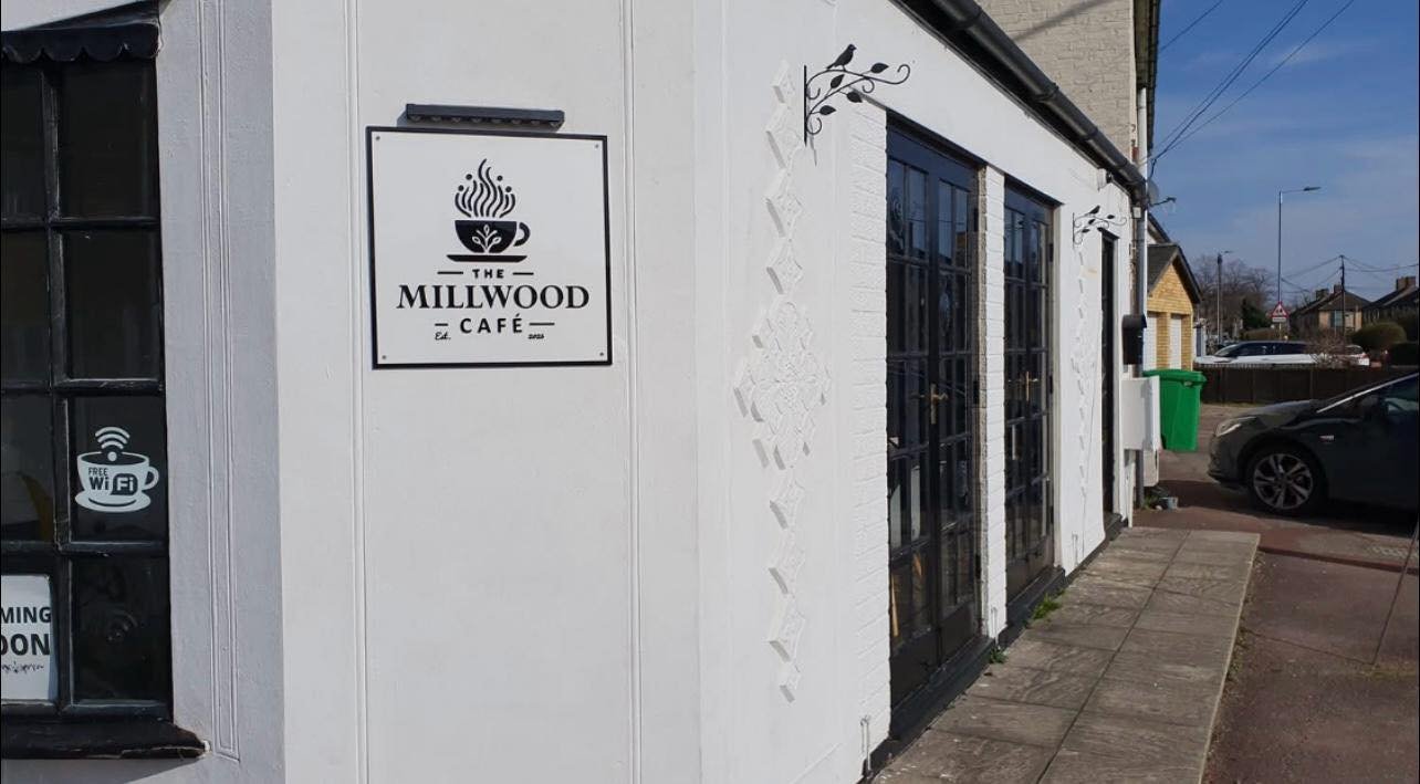 Interior view of The Millwood Café showing cozy seating area with warm lighting and welcoming atmosphere